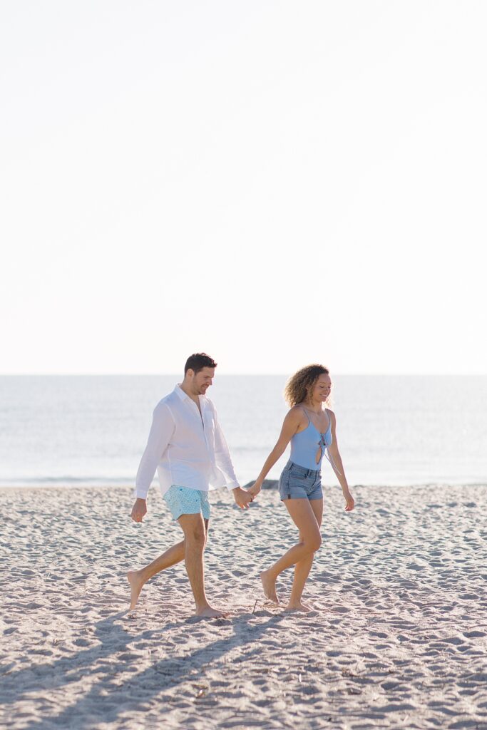 couple walking along the beach at Amelia Island Honeymoon Session photographed by Brittany Navin Photography 