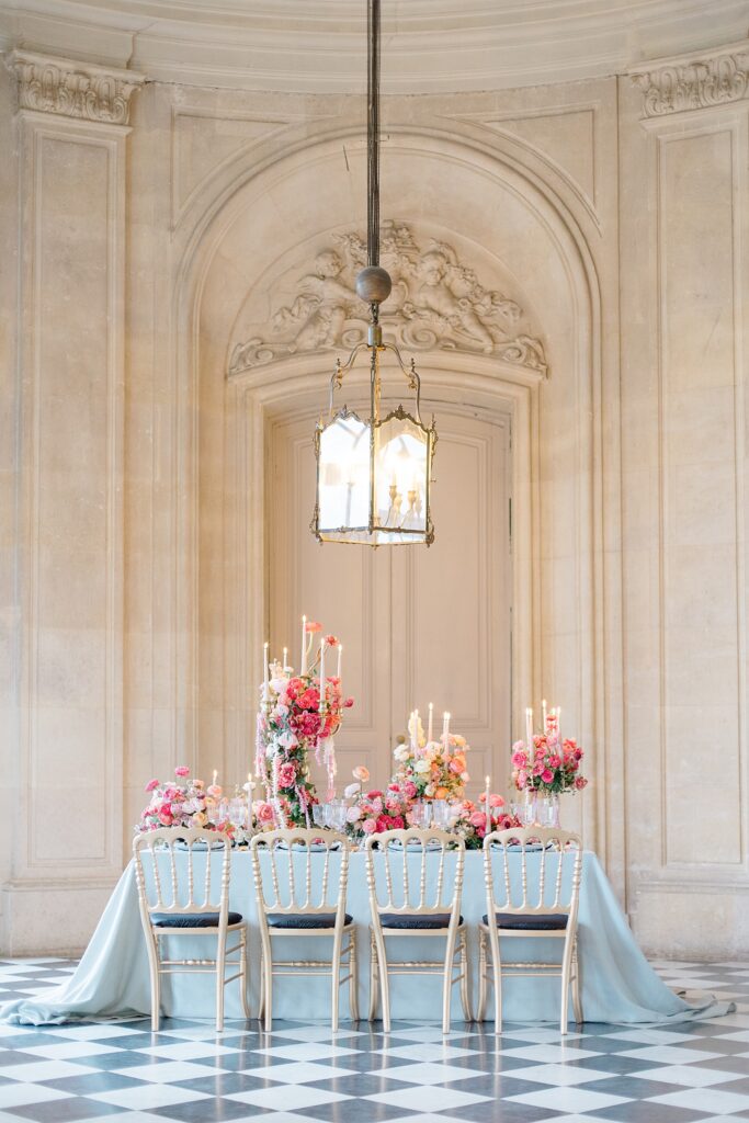 intimate wedding reception table scape with luscious blooms at Chateau De Champlatreux Wedding in Paris, France photographed by destination wedding photographer Brittany Navin Photography