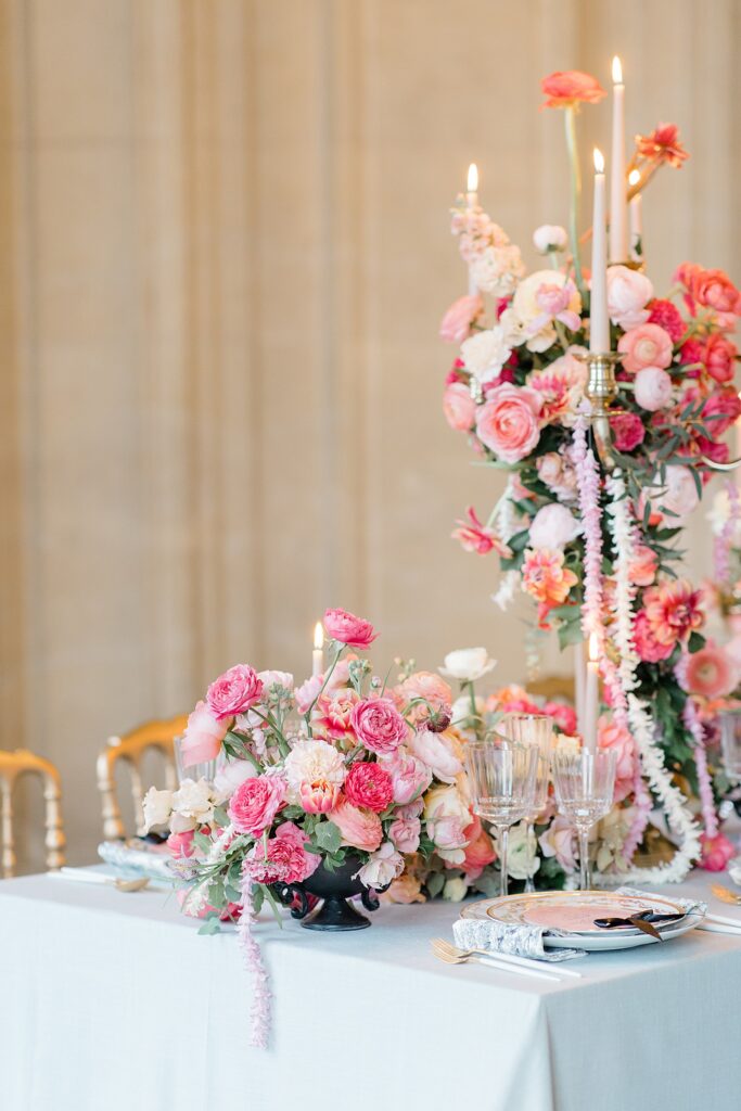 Luscious centre pieces with pops of pink at Chateau De Champlatreux Wedding in Paris, France photographed by destination wedding photographer Brittany Navin Photography