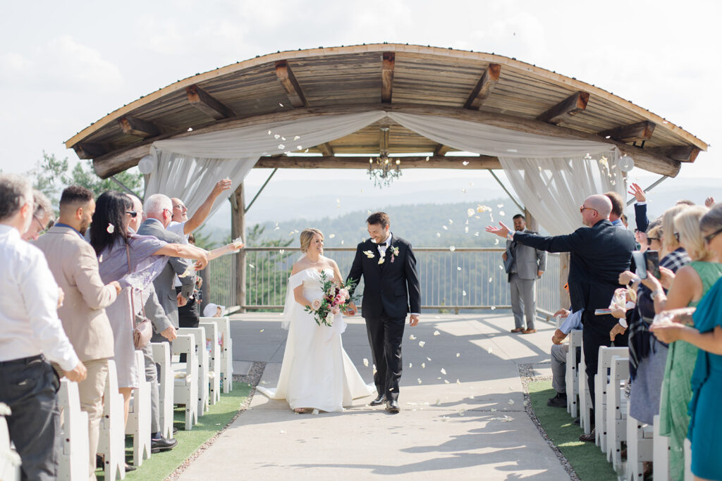 bride and groom have rose petal toss exit after ceremony at Le Belvedere Wedding photographed by Brittany Navin Photography, an Ottawa based Destination wedding photographer