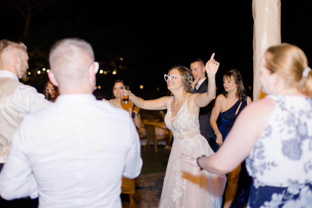 wedding reception dancing outdoors in the courtyard at Rome countryside wedding held at Tenuta La Porta Sul Lago photographed by Destination Wedding Photographer Brittany Navin Photography