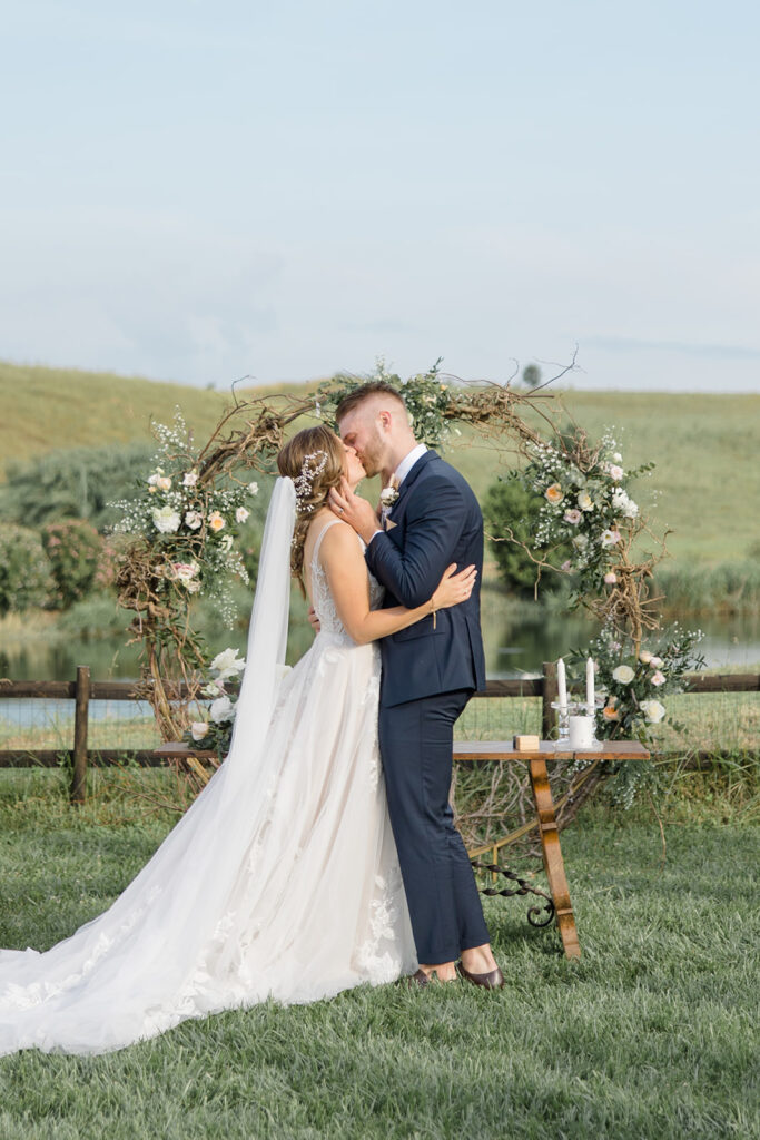 bride and groom first kiss at Rome countryside wedding held at Tenuta La Porta Sul Lago photographed by Destination Wedding Photographer Brittany Navin Photography