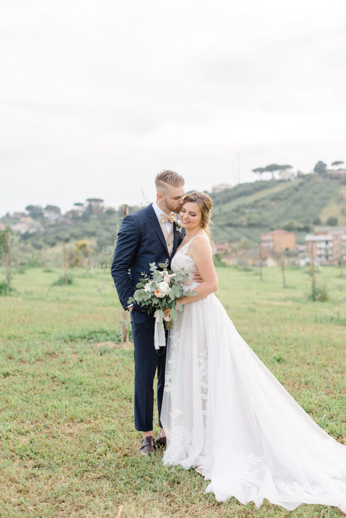bride and groom in the middle of a vineyard at Rome countryside wedding held at Tenuta La Porta Sul Lago photographed by Destination Wedding Photographer Brittany Navin Photography