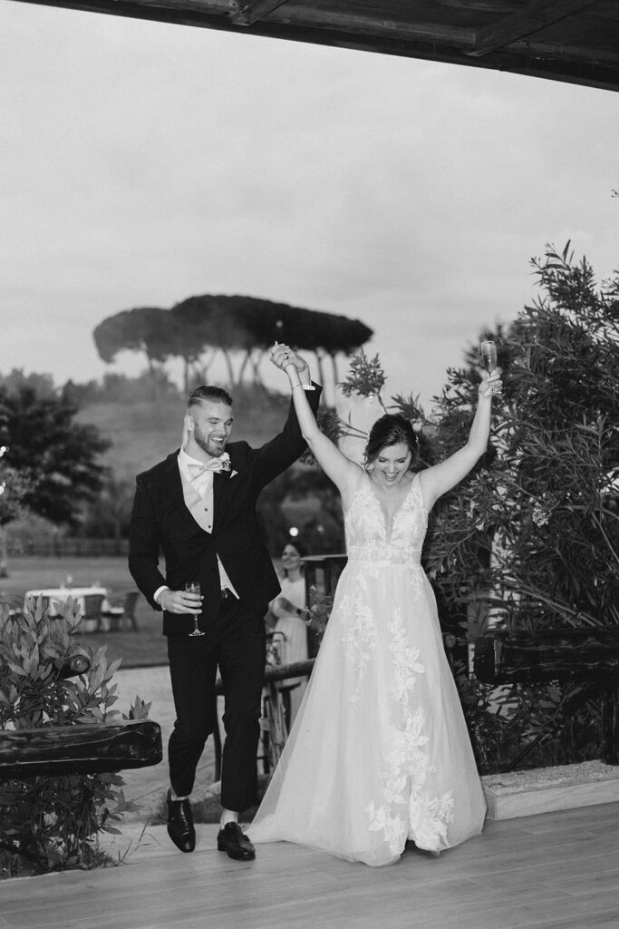 Bride and groom entering the wedding reception as husband and wife at Rome countryside wedding held at Tenuta La Porta Sul Lago photographed by Destination Wedding Photographer Brittany Navin Photography