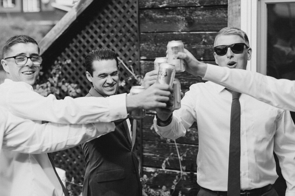 groom and groomsmen cheers as they prepare for the wedding day photographed by Brittany Navin Photography