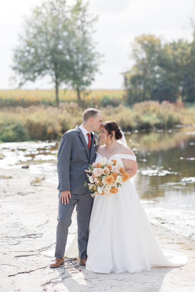 bride and groom portrait on the river rock at Bleeks and Bergamot wedding in Ashton, Ontario photographed by Ottawa wedding photographer, Brittany Navin Photography