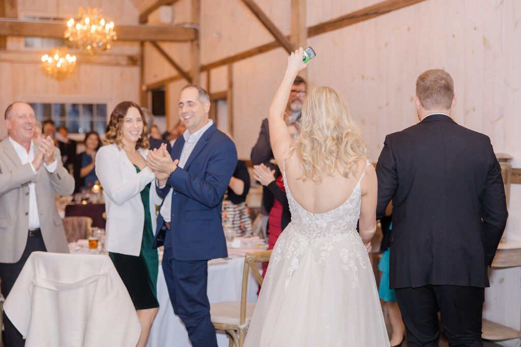 bride and groom making their way through the crowd of cheering guests at Stonefields Estate wedding photographed by Ottawa Wedding Photographer Brittany Navin Photography