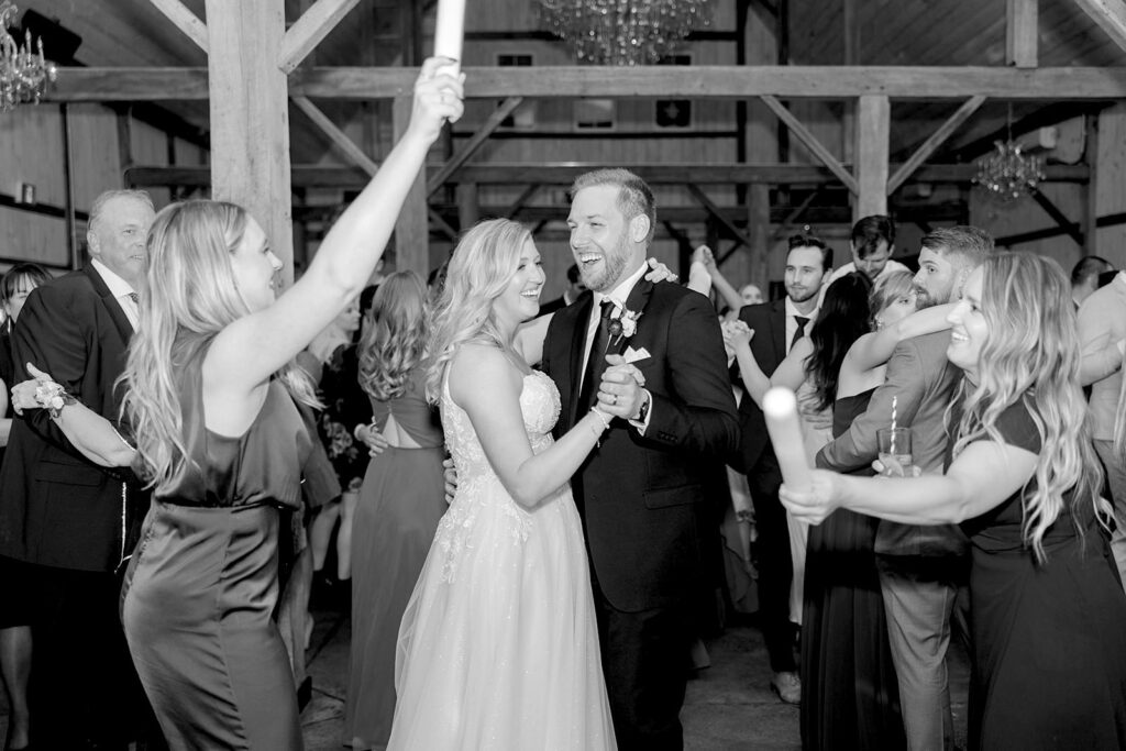 guest crowd around the bride and groom as everyone joins the dance floor at Stonefields Estate wedding photographed by Ottawa Wedding Photographer Brittany Navin Photography