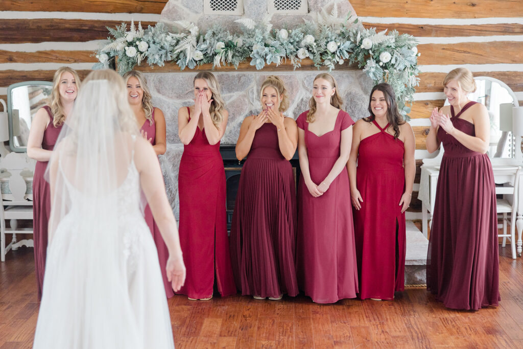bridesmaids first look reaction in the farmhouse at Stonefields Estate wedding photographed by Ottawa Wedding Photographer Brittany Navin Photography