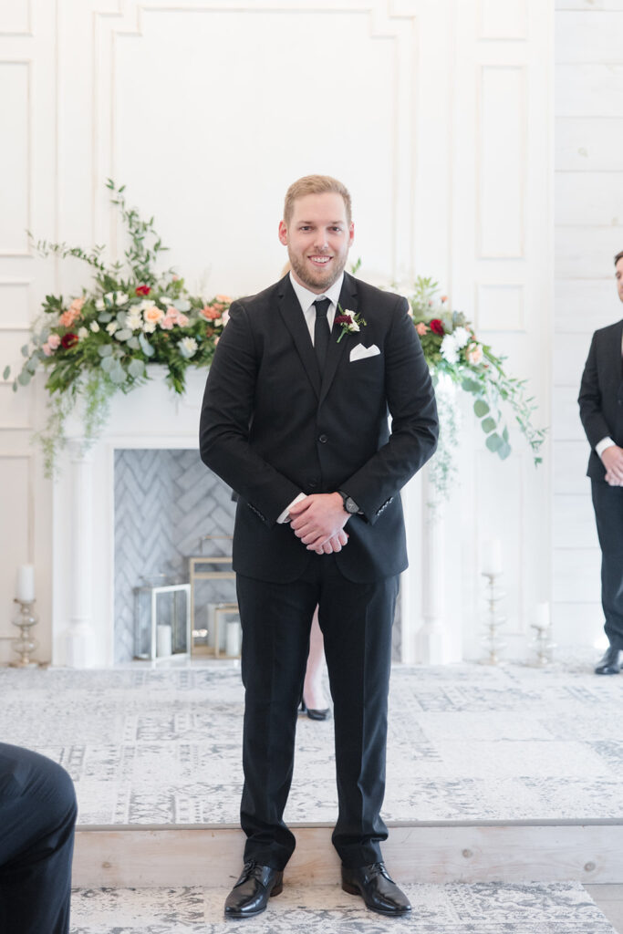 grooms reaction to seeing his bride come down the aisle at Stonefields Estate wedding photographed by Ottawa Wedding Photographer Brittany Navin Photography