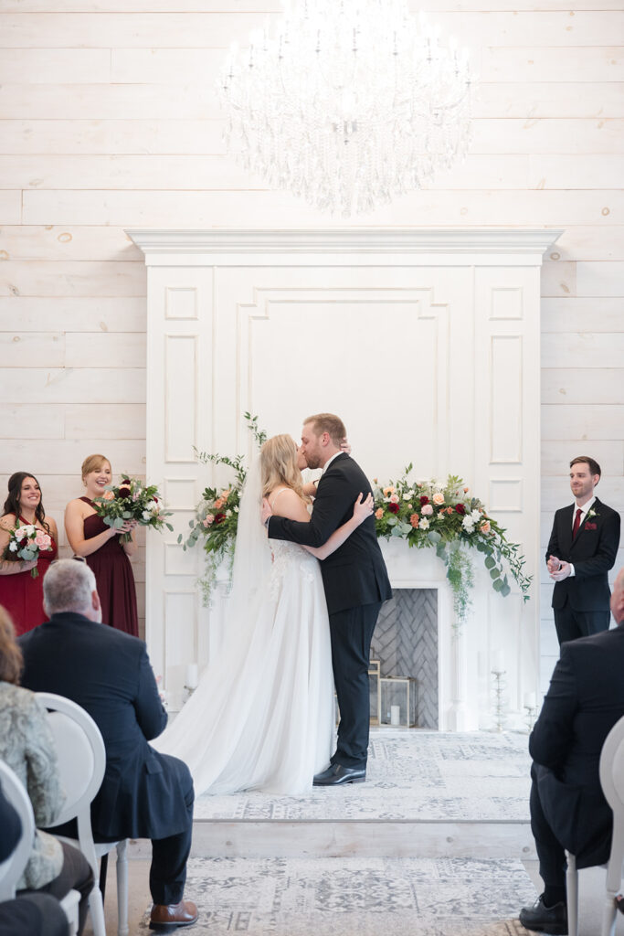 bride and groom first kiss at Stonefields Estate wedding photographed by Ottawa Wedding Photographer Brittany Navin Photography