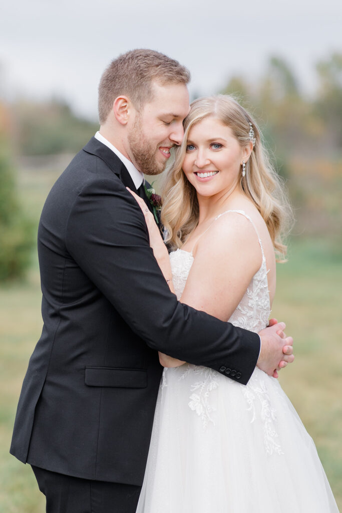 bride and groom cuddled up during portraits at Stonefields Estate wedding photographed by Ottawa Wedding Photographer Brittany Navin Photography
