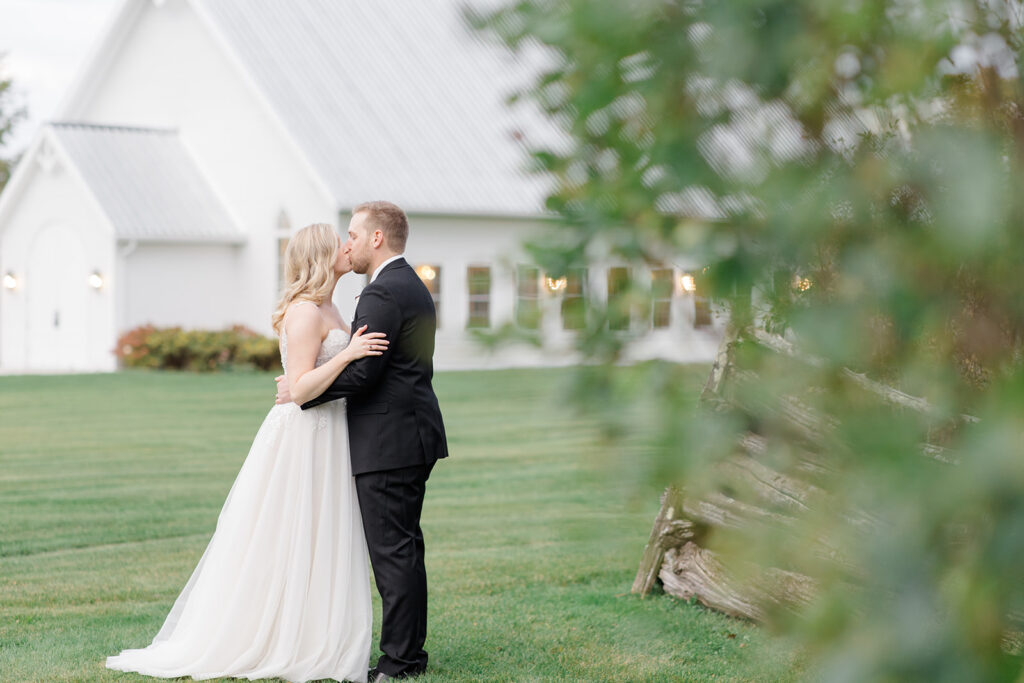 bride and groom share a kiss at Stonefields Estate wedding photographed by Ottawa Wedding Photographer Brittany Navin Photography