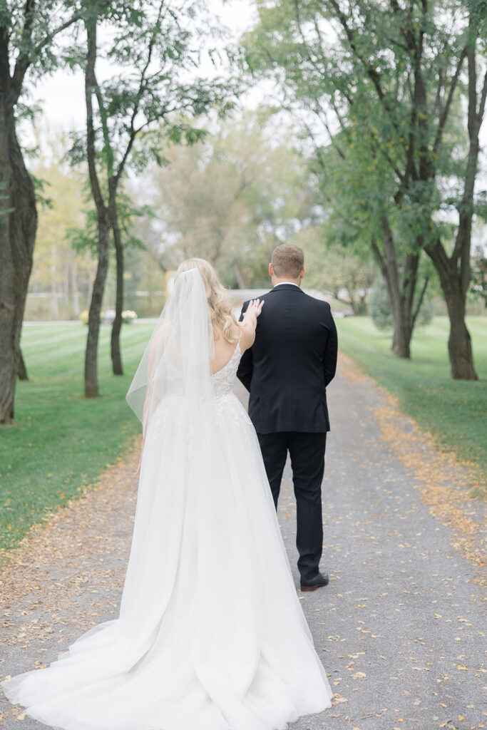 bride tapping groom on the shoulder for their first look at Stonefields Estate wedding photographed by Ottawa Wedding Photographer Brittany Navin Photographyat Stonefields Estate wedding photographed by Ottawa Wedding Photographer Brittany Navin Photography