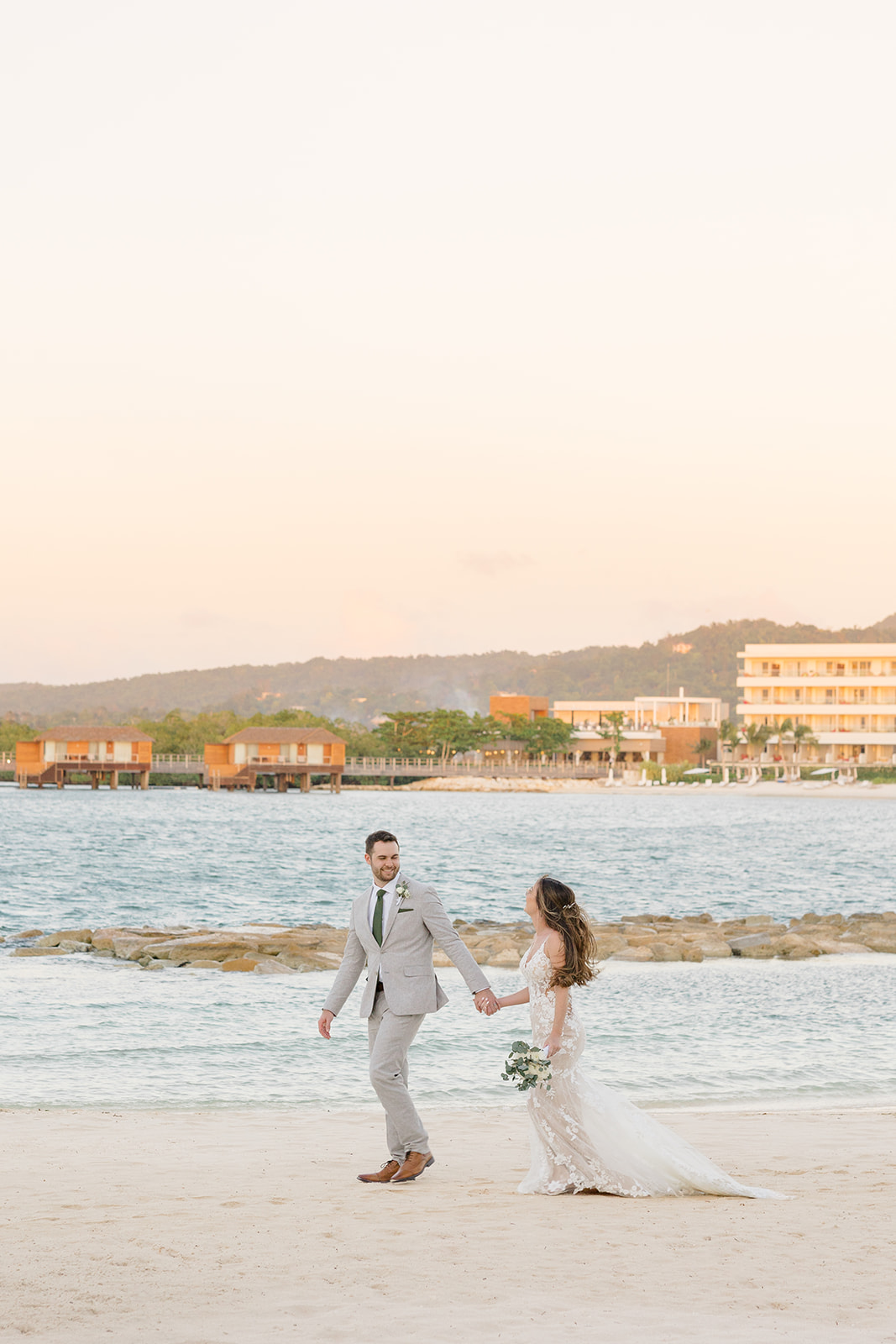 bride and groom walking on beach at destination wedding photographed by Ottawa wedding photographer, Brittany Navin
