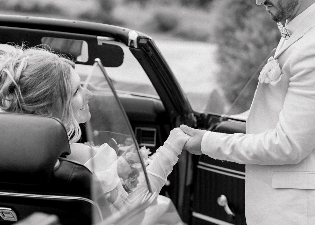 groom helping bride out of car at Le Peaches and Cream Wedding photographed by Ottawa wedding photographer, Brittany Navin