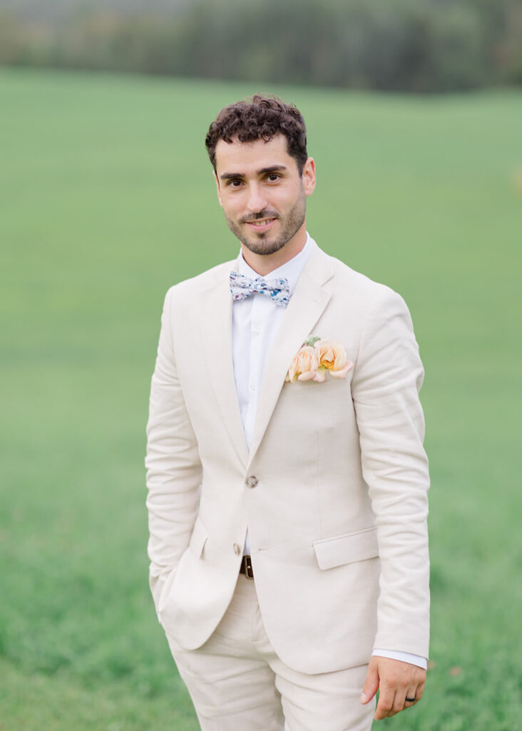 Groom portrait in a beige suit at Le Peaches and Cream Wedding photographed by Ottawa wedding photographer, Brittany Navin