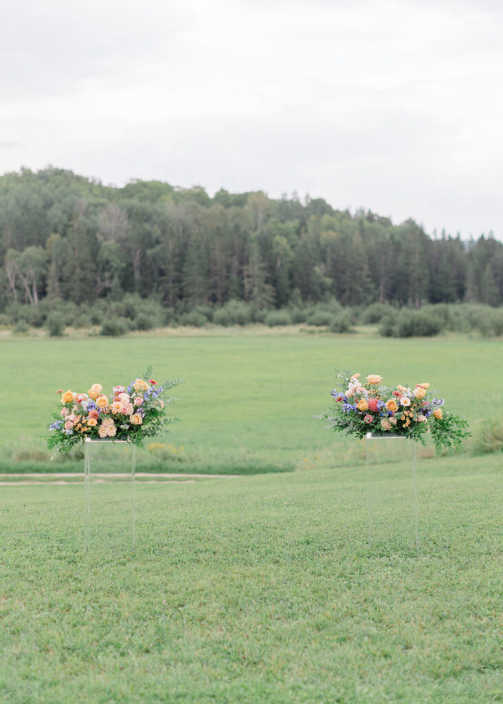 Ceremony set up in the country with peach, blush, and blue florals at Le Peaches and Cream Wedding photographed by Ottawa wedding photographer, Brittany Navin