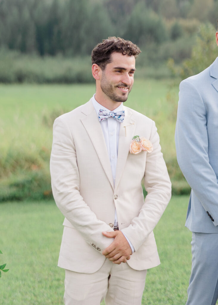 groom watching his bride come down the aisle at Le Peaches and Cream Wedding photographed by Ottawa wedding photographer, Brittany Navin